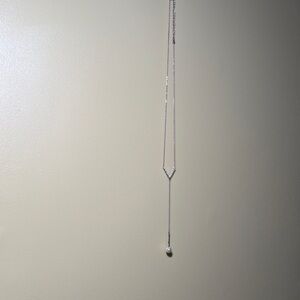 Elegant Silver Necklace with Long Chain and Dark Pendant
